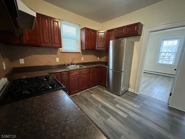 a kitchen with stainless steel appliances granite countertop a refrigerator stove and sink