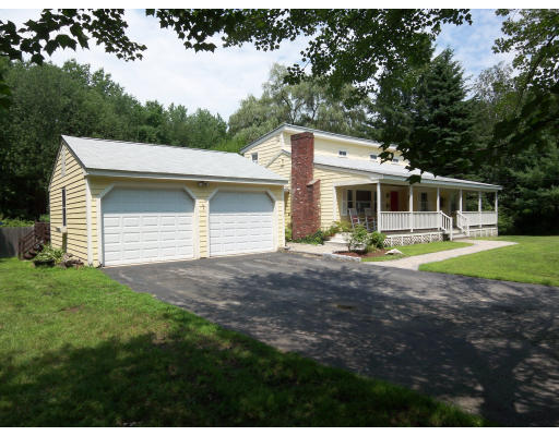 93 Concord Road Chelmsford, MA 01824 - Photo 1 of 18 a front view of a house with a yard and green space