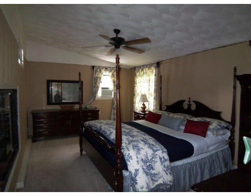 93 Concord Road Chelmsford, MA 01824 - Photo 12 of 18 a bedroom with a bed and a chandelier