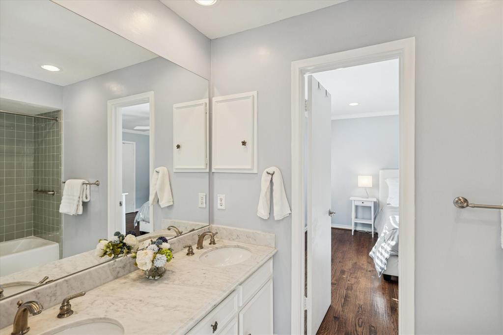 12650 Harriet Circle Dallas, TX 75244 - Photo 22 of 30 a en suite bathroom with a granite countertop sink and a large mirror