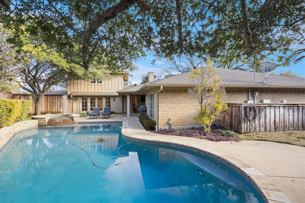 12650 Harriet Circle Dallas, TX 75244 - Photo 26 of 30 a view of a house with pool and chairs