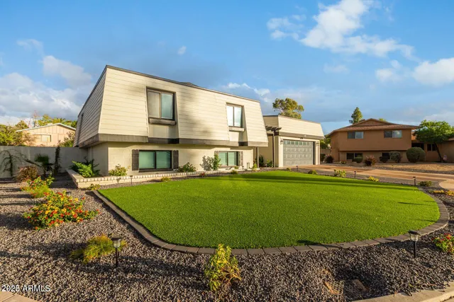 a view of a house with a backyard porch and sitting area