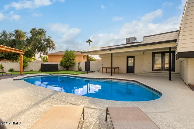 a view of a swimming pool with two chairs