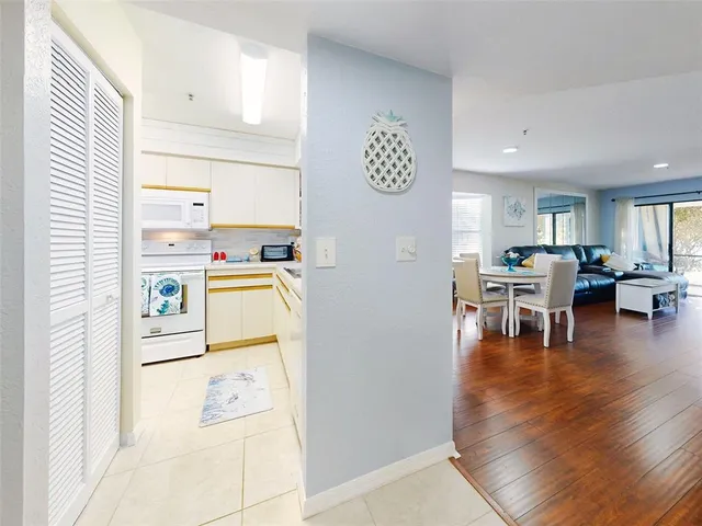 a view of kitchen with stainless steel appliances granite countertop refrigerator sink and stove