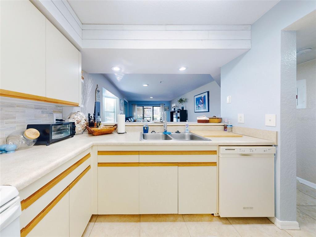 400 Bouchelle Drive, Unit 101 New Smyrna Beach, FL 32169 - Photo 15 of 63 a view of kitchen with stainless steel appliances granite countertop refrigerator sink and stove