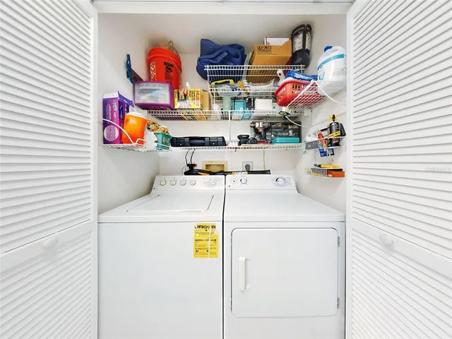 a en suite bathroom with a sink double vanity and wooden floor
