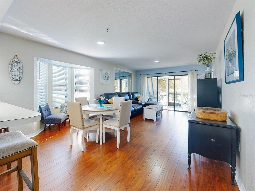 400 Bouchelle Drive, Unit 101 New Smyrna Beach, FL 32169 - Photo 19 of 63 a living room with furniture and a wooden floor