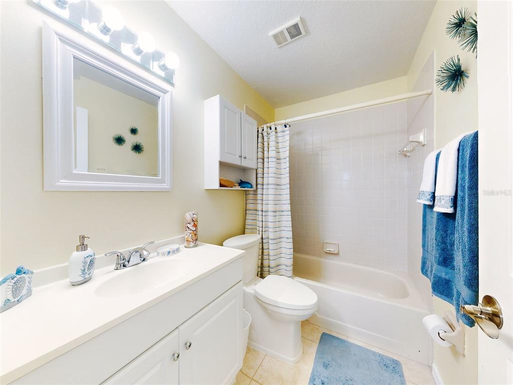 400 Bouchelle Drive, Unit 101 New Smyrna Beach, FL 32169 - Photo 20 of 63 a bathroom with a sink toilet tub and shower