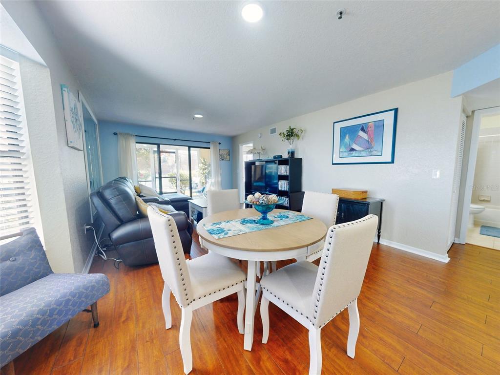 400 Bouchelle Drive, Unit 101 New Smyrna Beach, FL 32169 - Photo 25 of 63 a view of a dining room with furniture and wooden floor