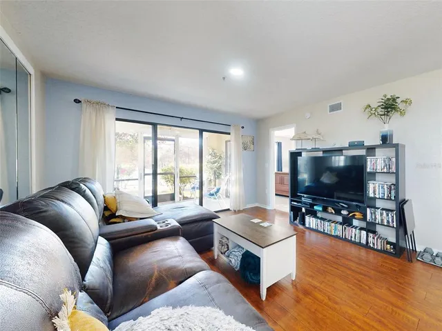 a view of an entryway with a floor to ceiling window and a living room
