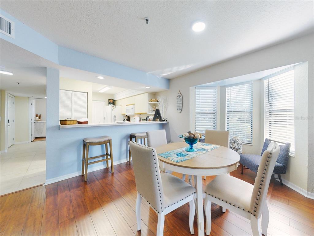 400 Bouchelle Drive, Unit 101 New Smyrna Beach, FL 32169 - Photo 28 of 63 a view of a dining room with furniture and wooden floor