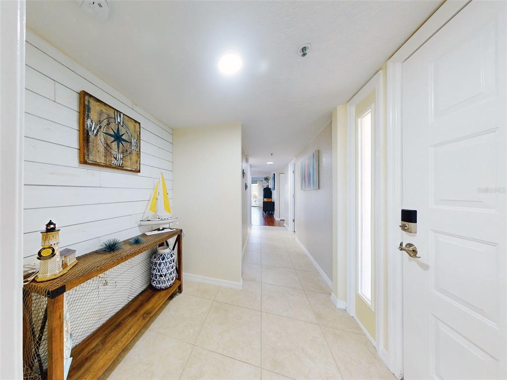 400 Bouchelle Drive, Unit 101 New Smyrna Beach, FL 32169 - Photo 3 of 63 a view of a hallway to a room with stair