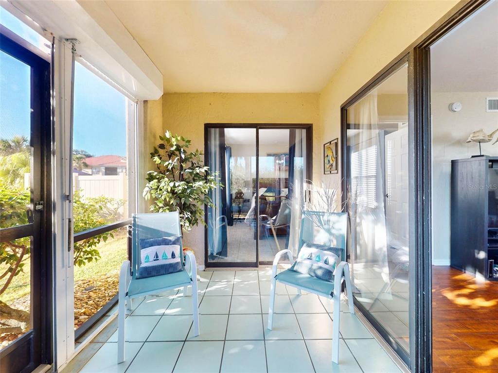 400 Bouchelle Drive, Unit 101 New Smyrna Beach, FL 32169 - Photo 35 of 63 a view of an entryway with a floor to ceiling window and a living room