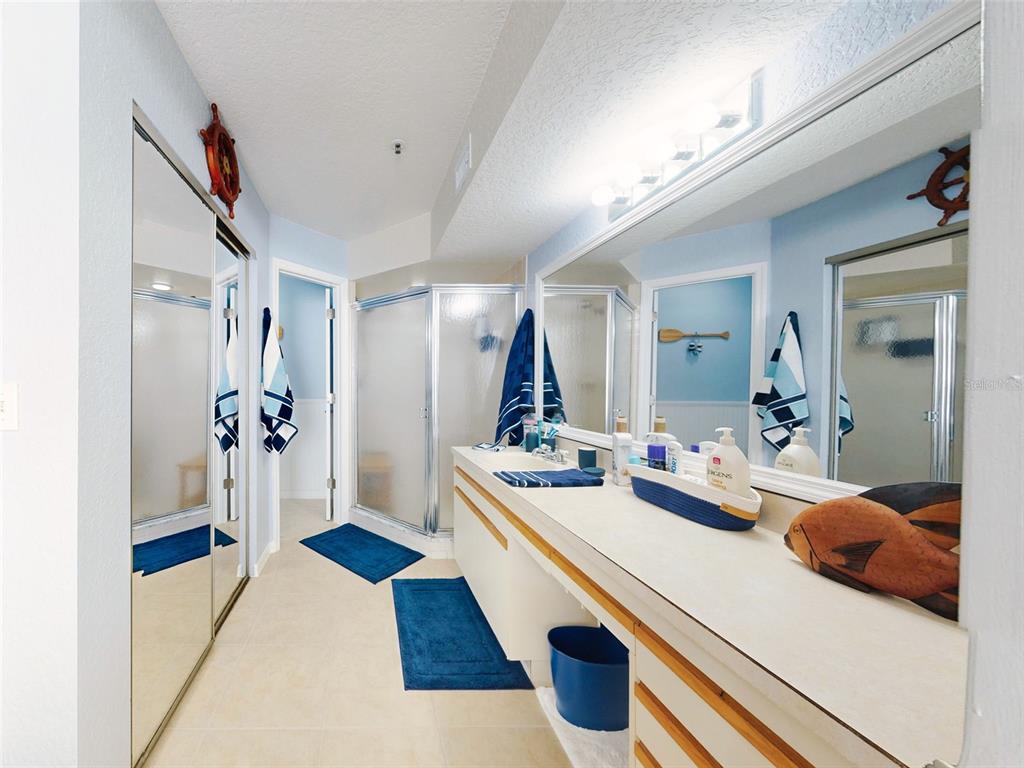 400 Bouchelle Drive, Unit 101 New Smyrna Beach, FL 32169 - Photo 37 of 63 a room with a bed and a large mirror