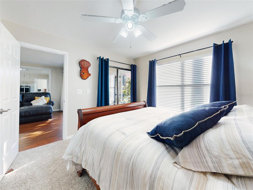 400 Bouchelle Drive, Unit 101 New Smyrna Beach, FL 32169 - Photo 39 of 63 a bedroom with a large bed and a large window