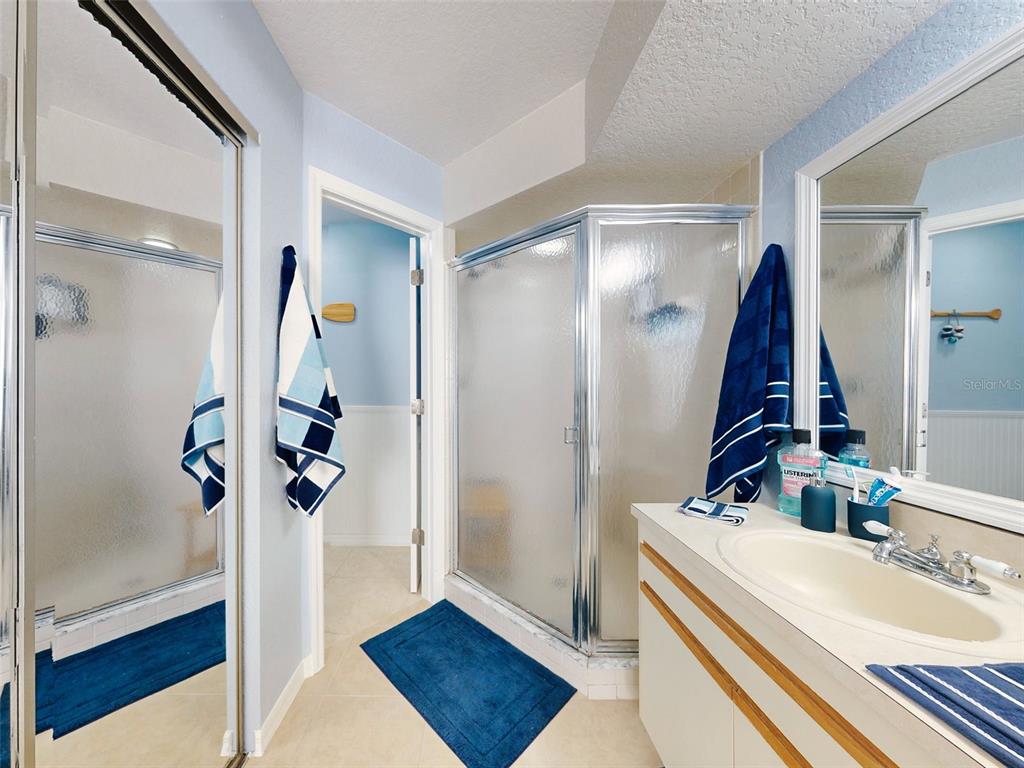 400 Bouchelle Drive, Unit 101 New Smyrna Beach, FL 32169 - Photo 41 of 63 a bathroom with a sink and a mirror