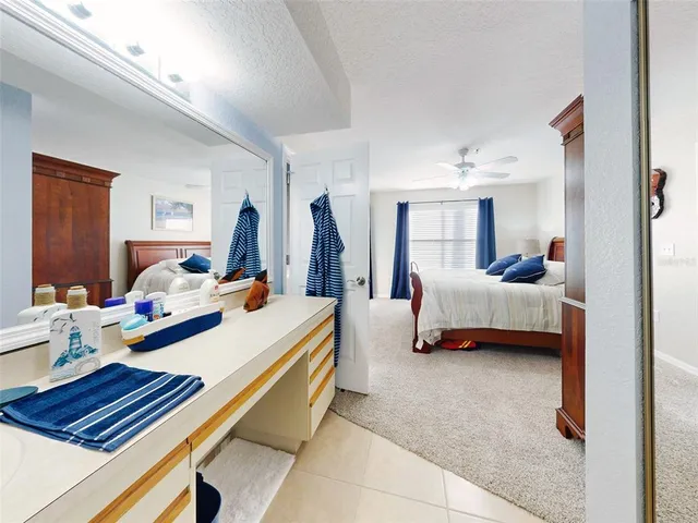 a view of a patio with table and chairs under an umbrella