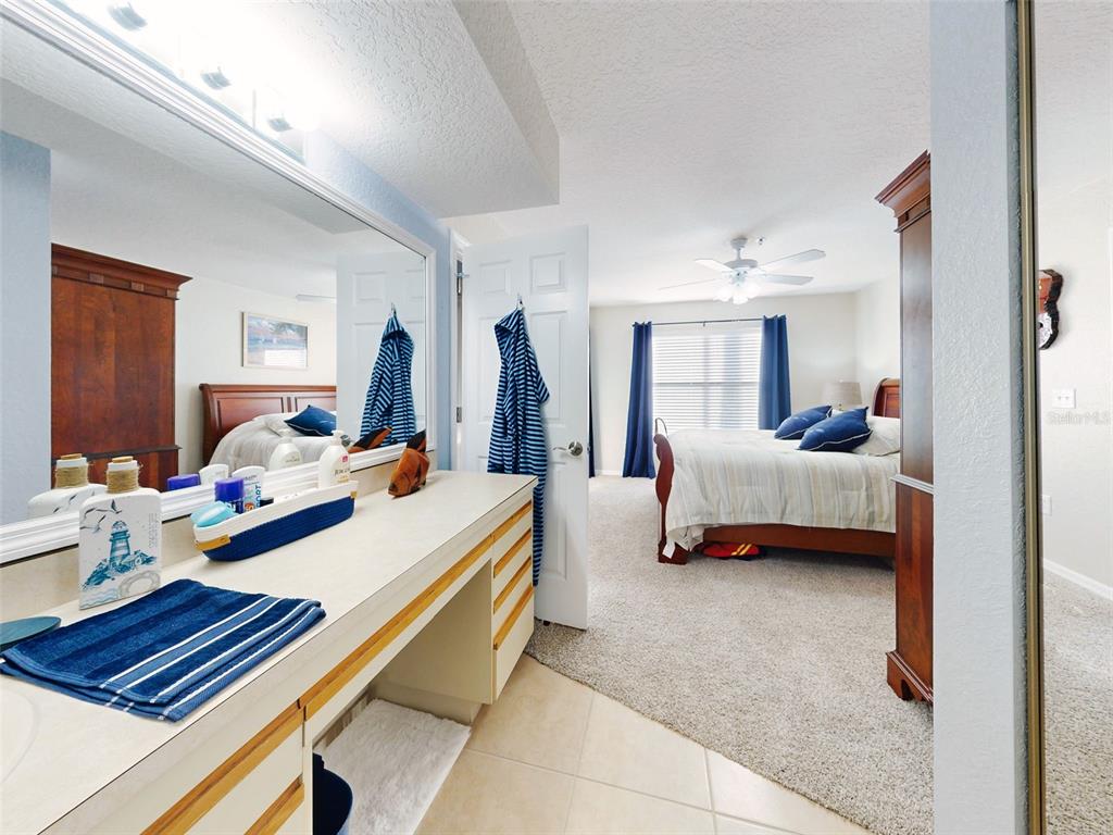 400 Bouchelle Drive, Unit 101 New Smyrna Beach, FL 32169 - Photo 42 of 63 a bed room with a bed and a couch