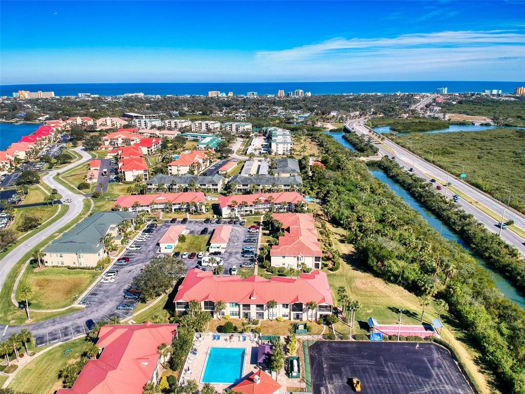 400 Bouchelle Drive, Unit 101 New Smyrna Beach, FL 32169 - Photo 45 of 63 an aerial view of residential building and city