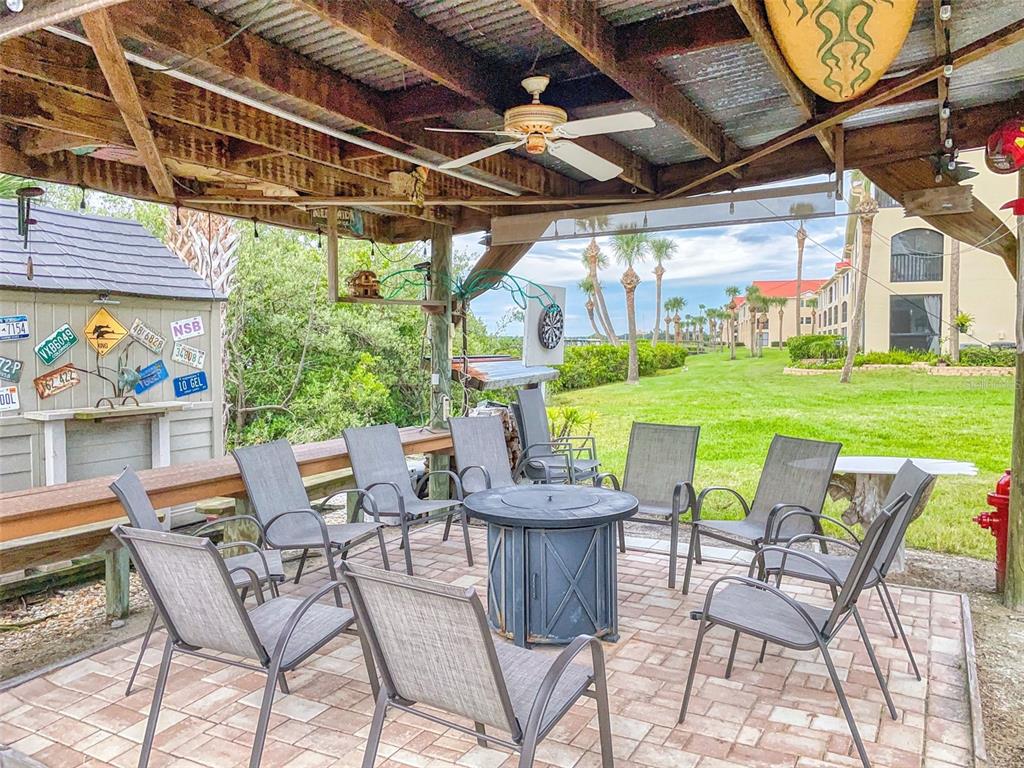 400 Bouchelle Drive, Unit 101 New Smyrna Beach, FL 32169 - Photo 52 of 63 a view of an chairs and table in the patio