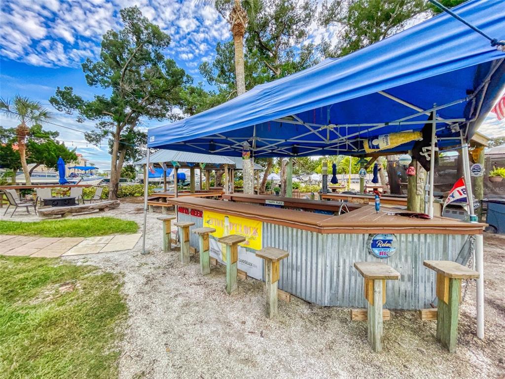 400 Bouchelle Drive, Unit 101 New Smyrna Beach, FL 32169 - Photo 54 of 63 a view of a patio with table and chairs under an umbrella