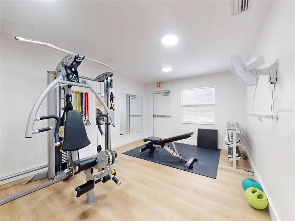 400 Bouchelle Drive, Unit 101 New Smyrna Beach, FL 32169 - Photo 58 of 63 a view of a room with gym equipment