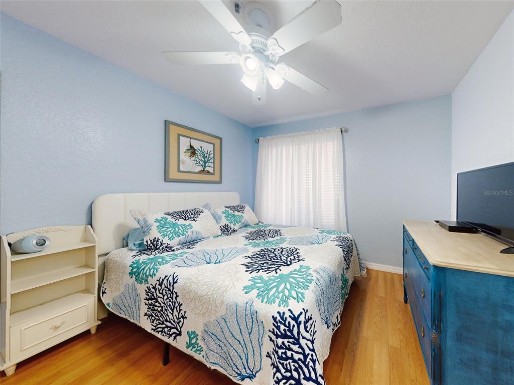400 Bouchelle Drive, Unit 101 New Smyrna Beach, FL 32169 - Photo 9 of 63 a bedroom with a bed and a desk