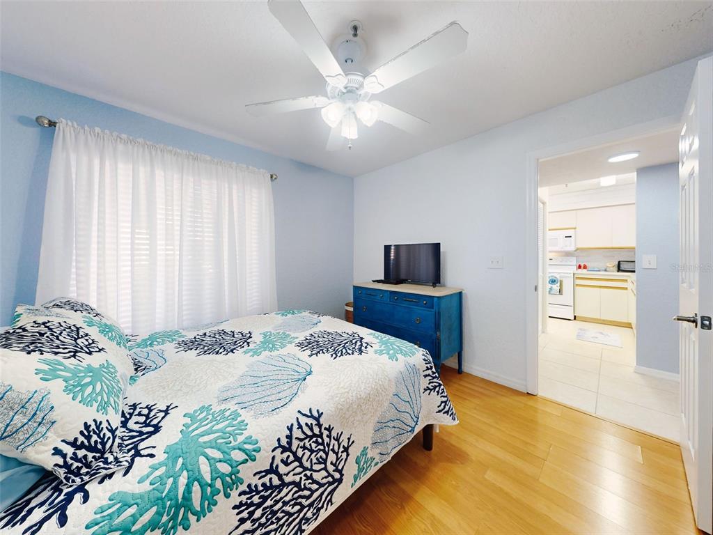 400 Bouchelle Drive, Unit 101 New Smyrna Beach, FL 32169 - Photo 10 of 63 a bedroom with a bed and a tv