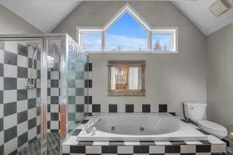 a bathroom with a bathtub and a shower