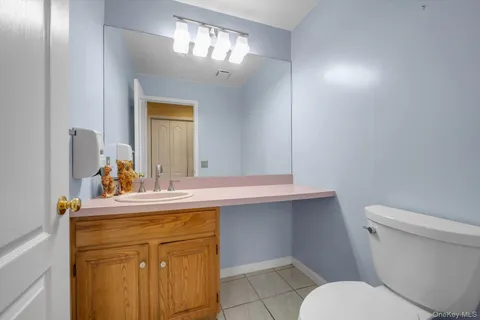 a bathroom with a sink a toilet and mirror