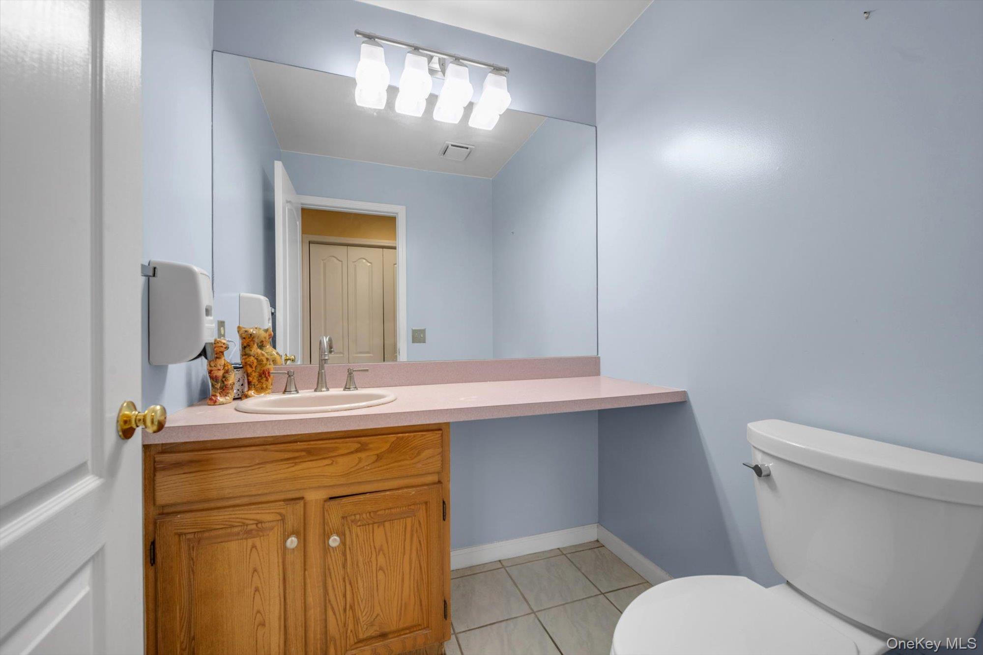 4 Greenlawn Road Cortlandt Manor, NY 10567 - Photo 17 of 26 a bathroom with a sink a toilet and mirror