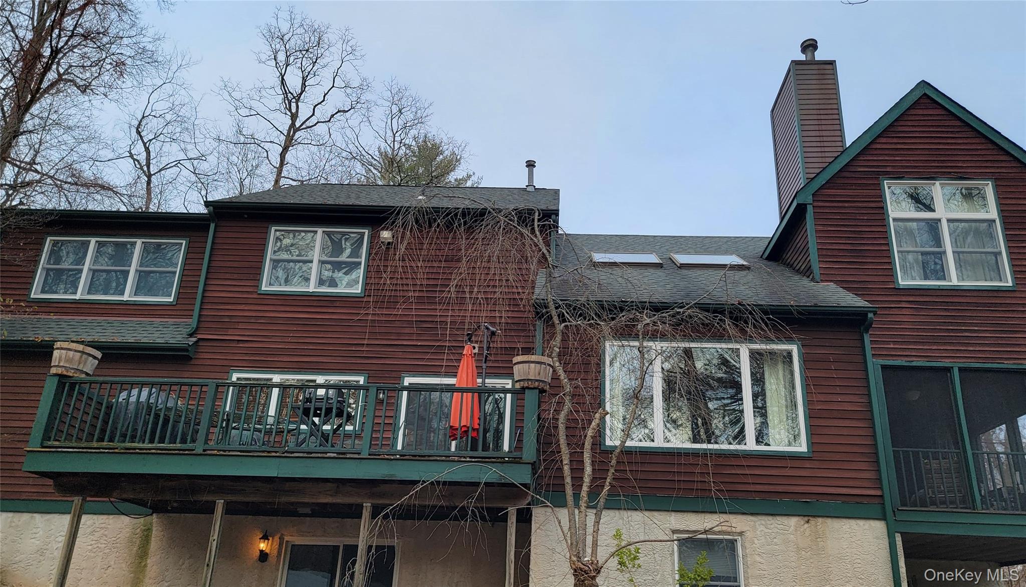 4 Greenlawn Road Cortlandt Manor, NY 10567 - Photo 18 of 24 Rear view of property with a shingled roof, a chimney, and a balcony