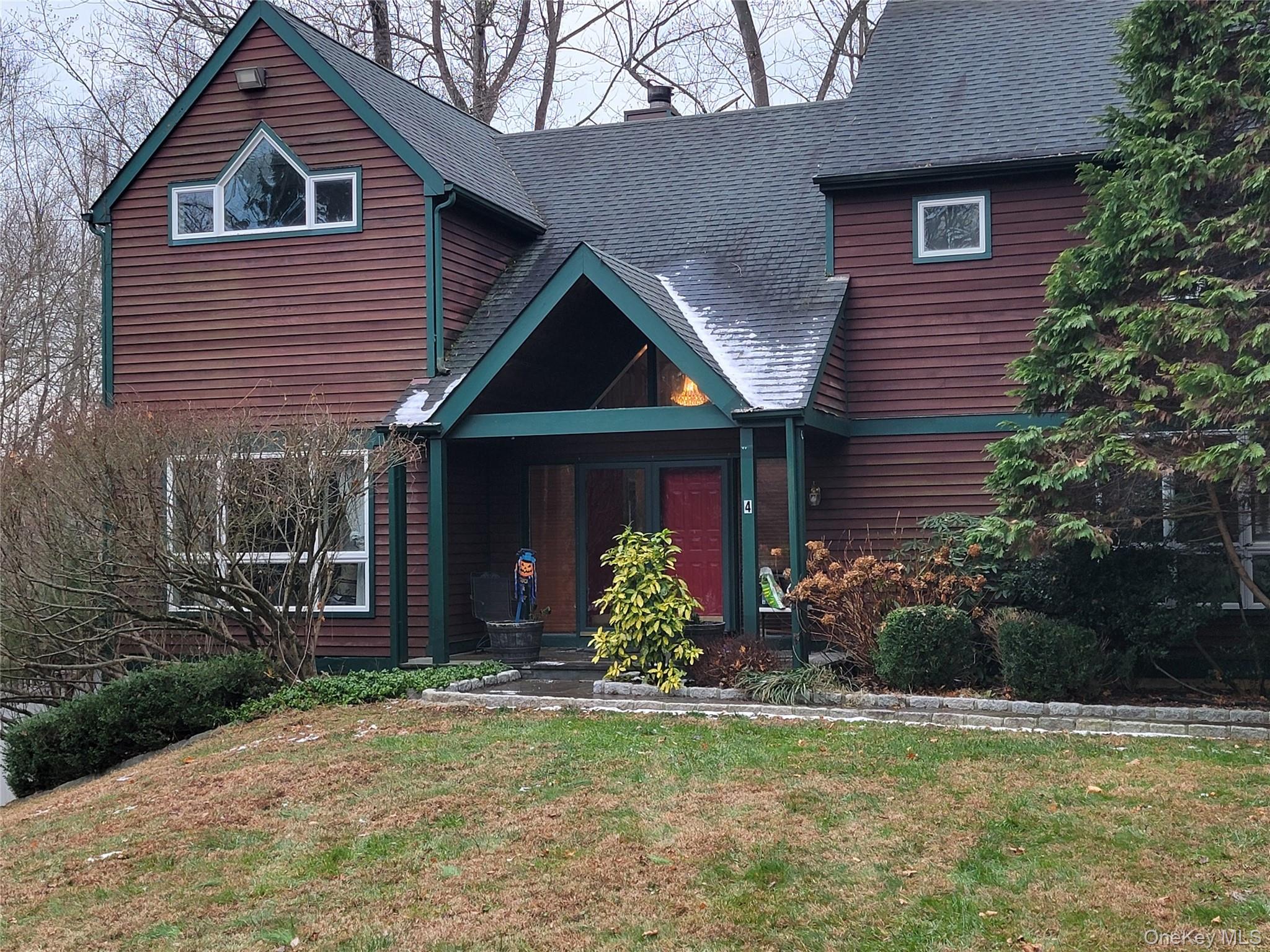 4 Greenlawn Road Cortlandt Manor, NY 10567 - Photo 2 of 26 a front view of a house with garden