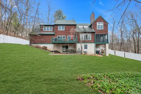 a view of a yard with potted plants and large trees