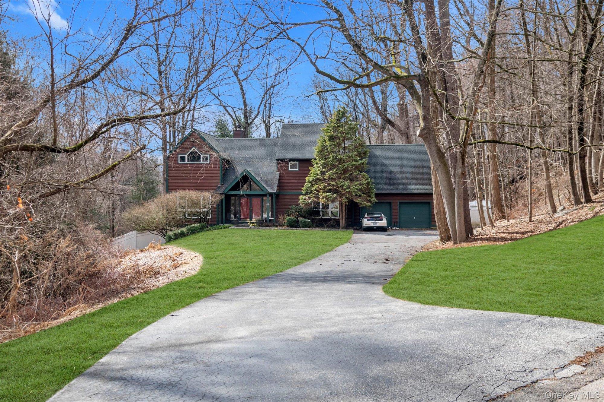 4 Greenlawn Road Cortlandt Manor, NY 10567 - Photo 23 of 26 a view of a yard with flower plants and large trees