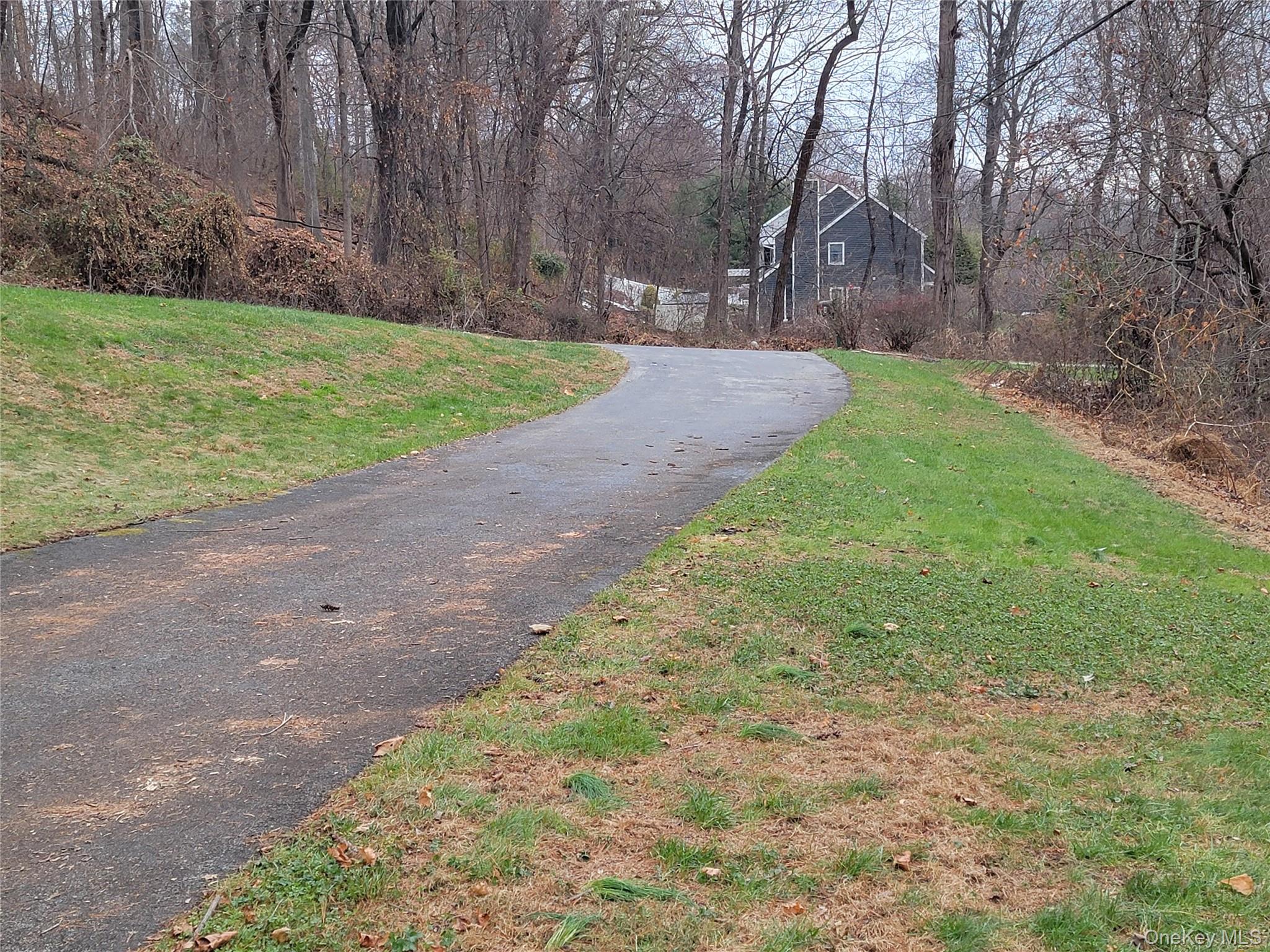 4 Greenlawn Road Cortlandt Manor, NY 10567 - Photo 24 of 26 a view of a yard with potted plants and large trees