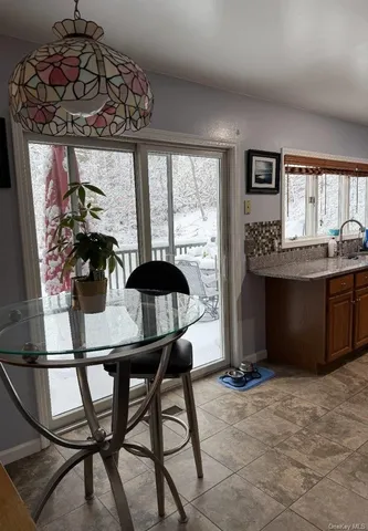 a dining room with furniture and window