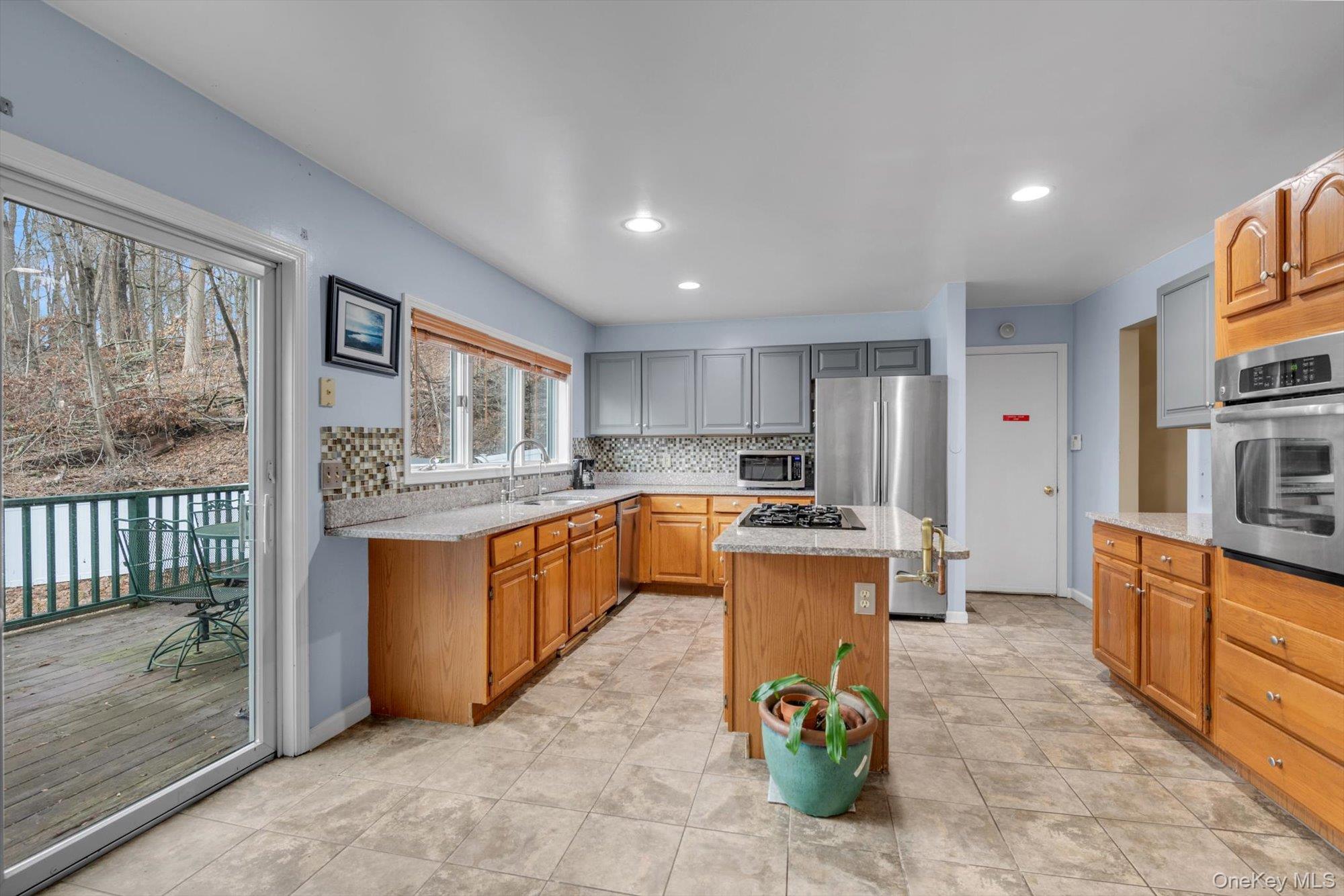 4 Greenlawn Road Cortlandt Manor, NY 10567 - Photo 3 of 26 a kitchen with a refrigerator and a stove top oven