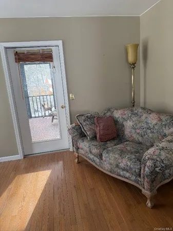 a living room with a bed and a window