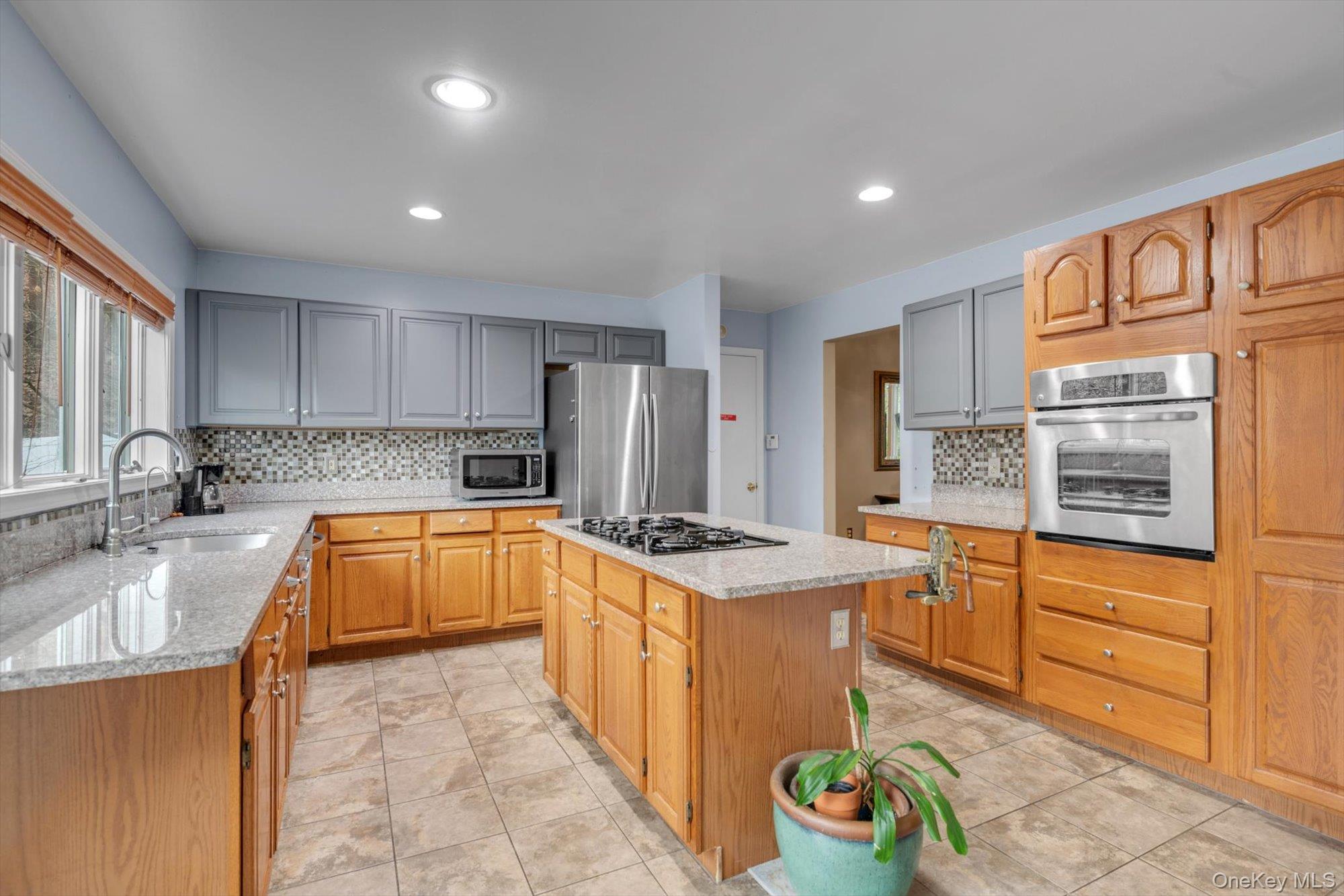 4 Greenlawn Road Cortlandt Manor, NY 10567 - Photo 4 of 26 a kitchen with stainless steel appliances granite countertop a sink stove and refrigerator