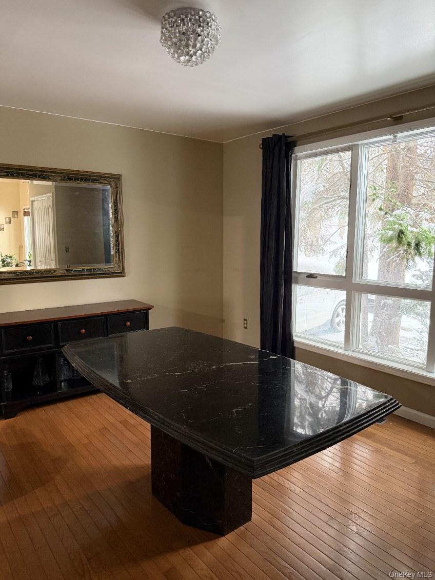 4 Greenlawn Road Cortlandt Manor, NY 10567 - Photo 7 of 24 Kitchen with hardwood / wood-style flooring and dark stone counters