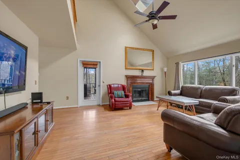 a living room with furniture large window and a fireplace