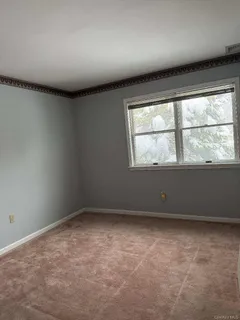 an empty room with a empty space and windows