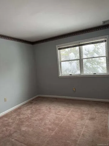 an empty room with a empty space and windows