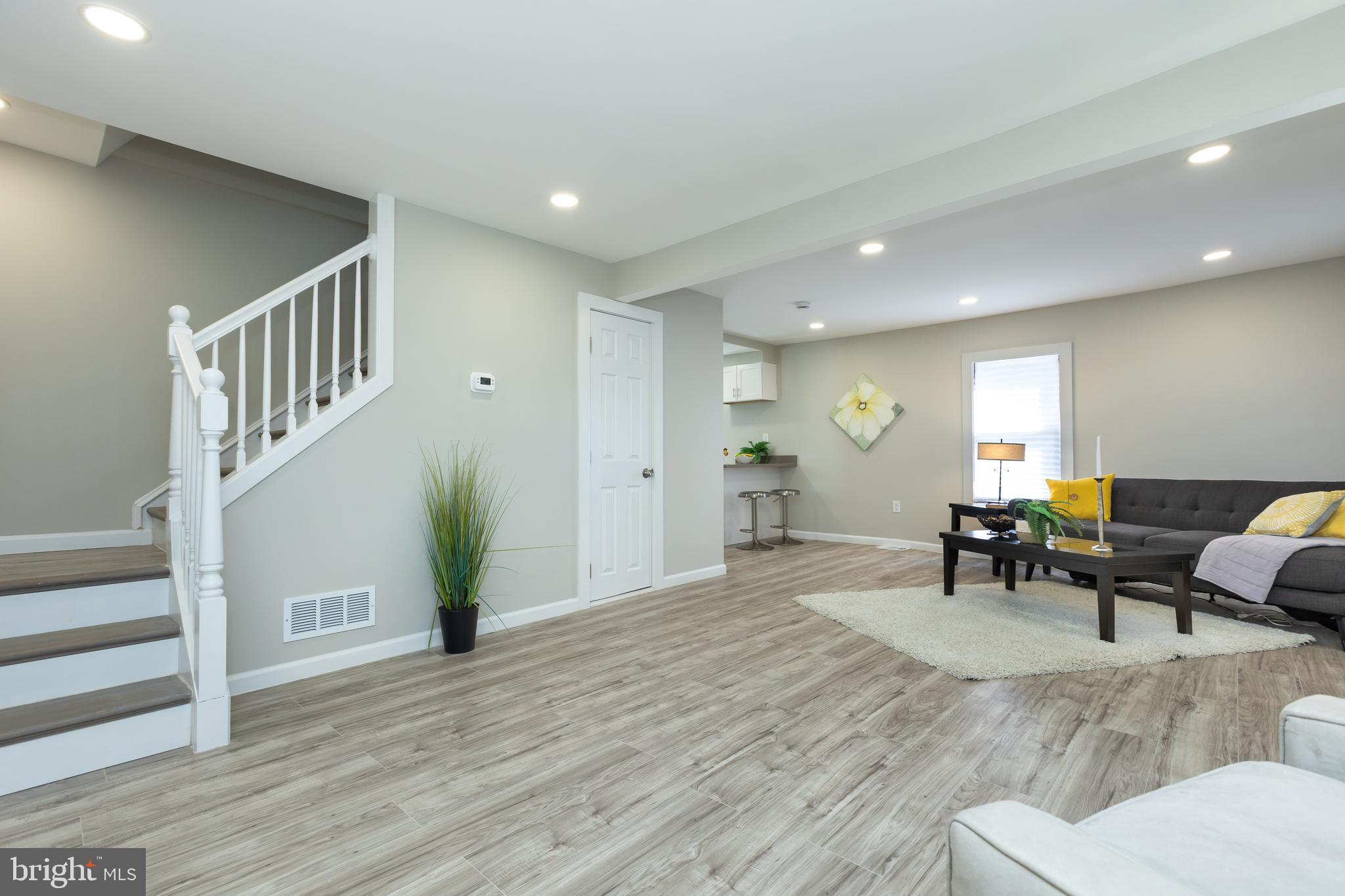 2407 Hammonds Ferry Road Halethorpe, MD 21227 - Photo 18 of 43 a living room with furniture and wooden floor