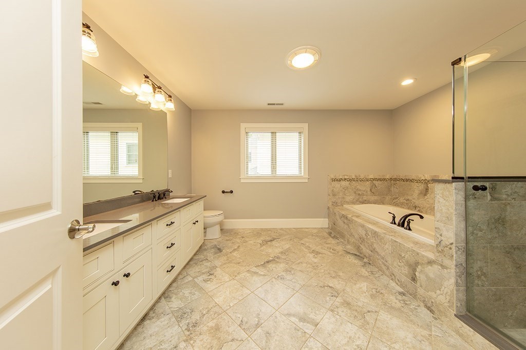 33 Liberty Avenue Lexington, MA 02420 - Photo 15 of 30 a bathroom with a tub sink and mirror