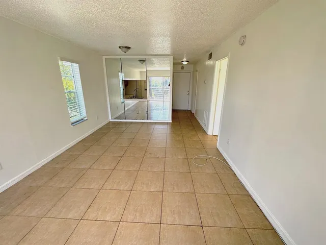 a view of hallway with a sink and a refrigerator