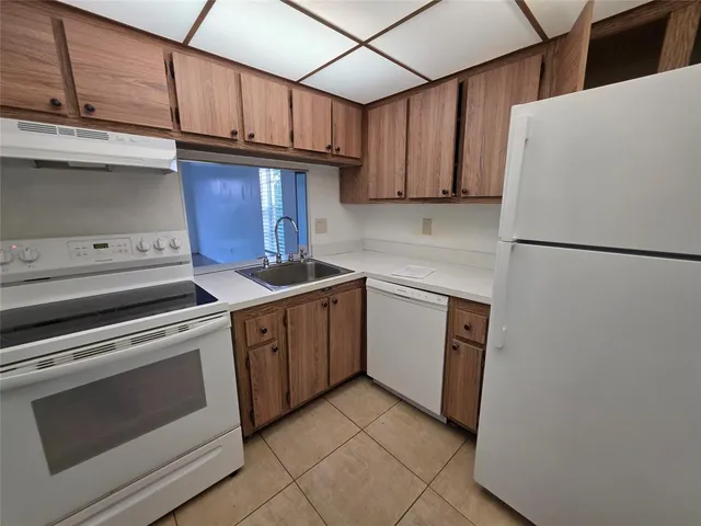 a kitchen with a stove cabinets and a refrigerator