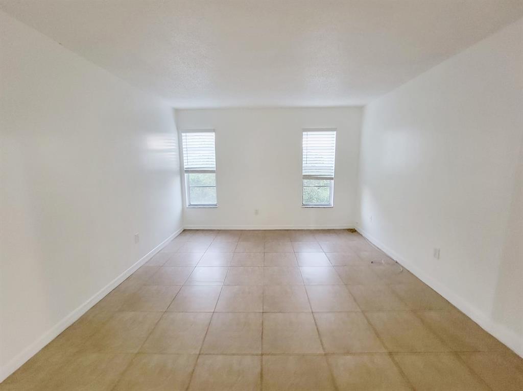 2800 Northwest 56th Avenue, Unit E407 Lauderhill, FL 33313 - Photo 5 of 15 wooden floor in an empty room with a window