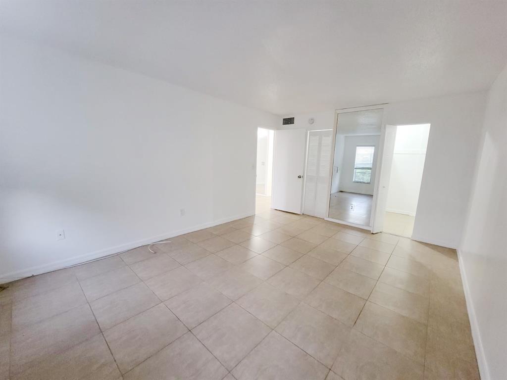 2800 Northwest 56th Avenue, Unit E407 Lauderhill, FL 33313 - Photo 6 of 15 a view of an empty room and window